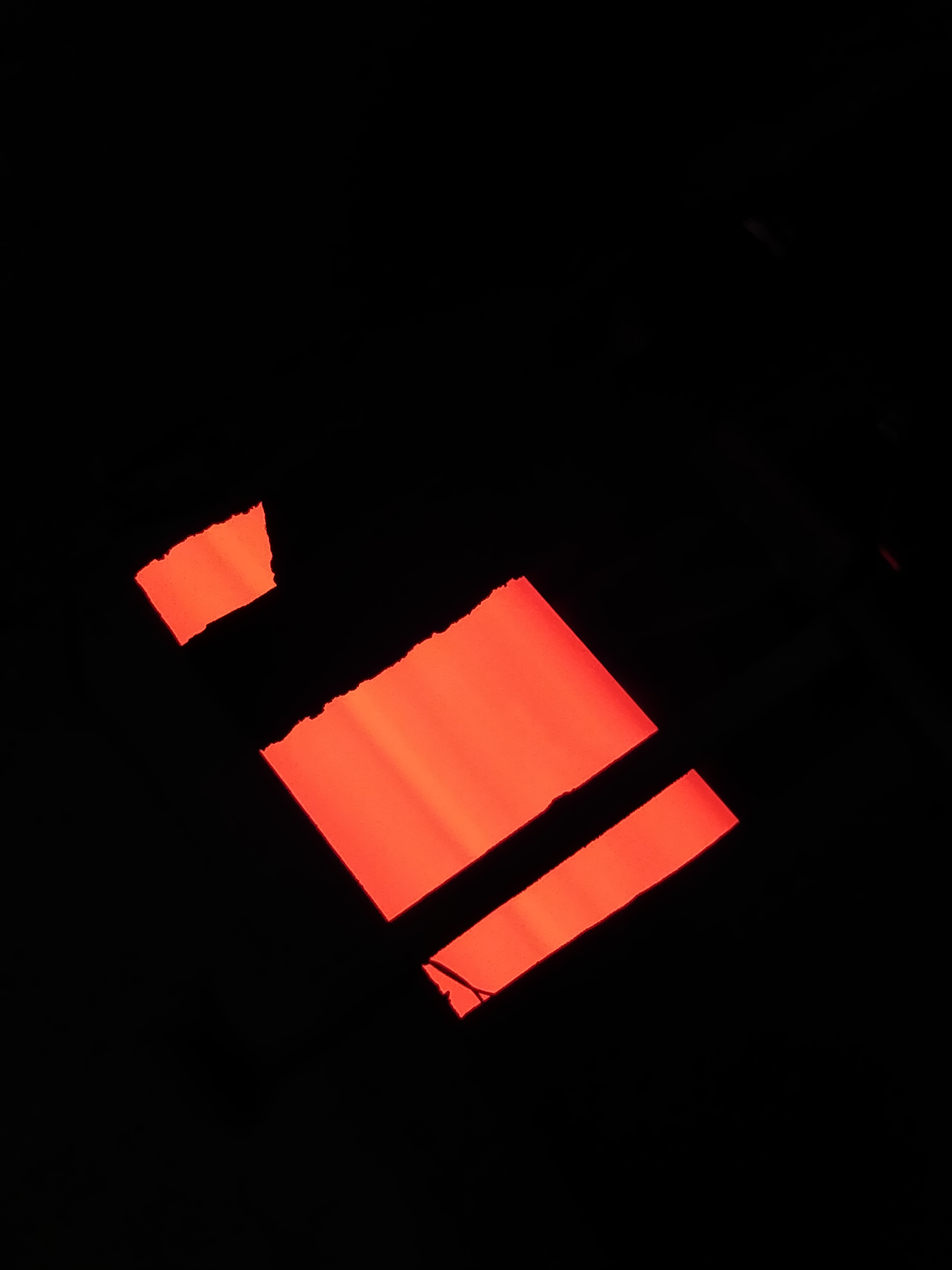 Glowing steel strip viewed through openings near the line